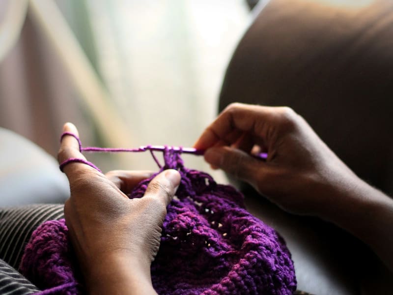 Hands sewing fabric by hand
